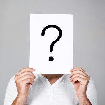 advanced system repair system optimizers safe man in white shirt holding question mark sign in  front of his head gray background